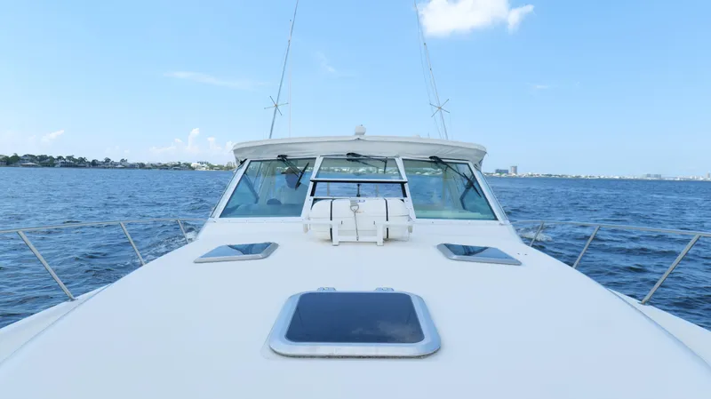 Extremely Clean Boat Yacht Photos Pics Tiara Yachts 3700 Open 2000 model cruising on open water under clear blue sky.