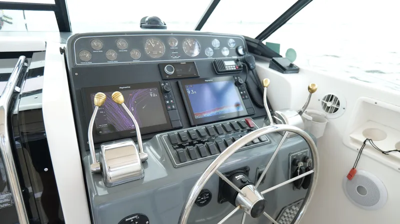 Extremely Clean Boat Yacht Photos Pics Helm of 2000 Tiara Yachts 3700 Open with navigation screens and controls.