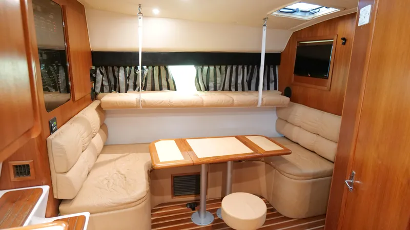 Extremely Clean Boat Yacht Photos Pics Interior of 2000 Tiara Yachts 3700 Open, featuring cozy seating and wooden accents.