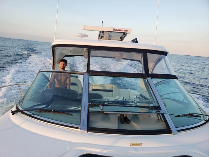 Freedom Yacht Photos Pics 2004 Sea Ray 390 Sundancer cruising on open water, clear sky, person at helm.