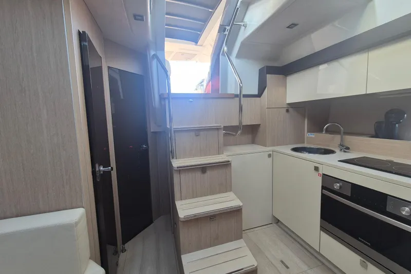  Yacht Photos Pics Interior of 2015 Cranchi M 44 HT yacht with modern kitchen and stairs.