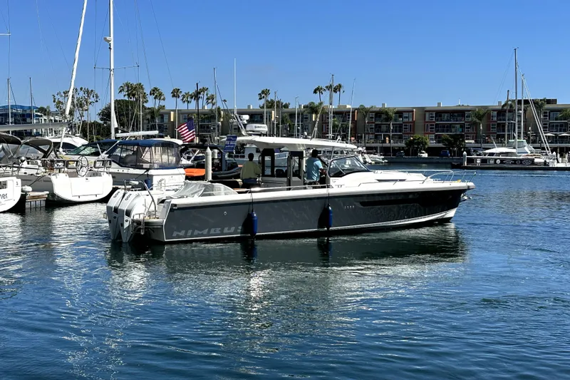 Mdr #187 In Stock Yacht Photos Pics 2023 Nimbus T11 boat docked in a marina with clear blue skies.