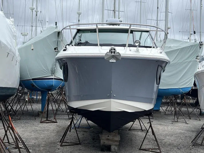  Yacht Photos Pics 2023 Sea Ray Sundancer 320 yacht in dry dock, surrounded by covered boats.