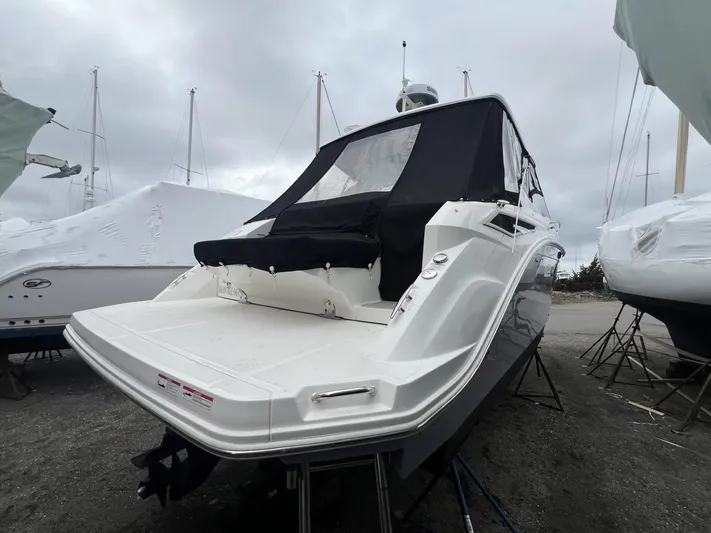  Yacht Photos Pics 2023 Sea Ray Sundancer 320 boat with covered deck, docked on land.
