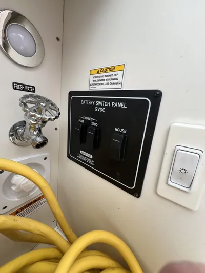  Yacht Photos Pics 2023 Sea Ray Sundancer 320 battery switch panel with fresh water access and caution label.