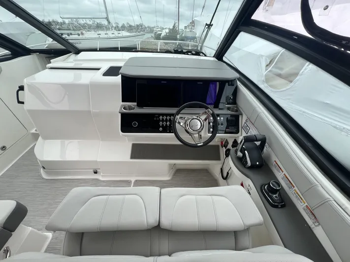  Yacht Photos Pics 2023 Sea Ray Sundancer 320 helm with modern controls and sleek design.