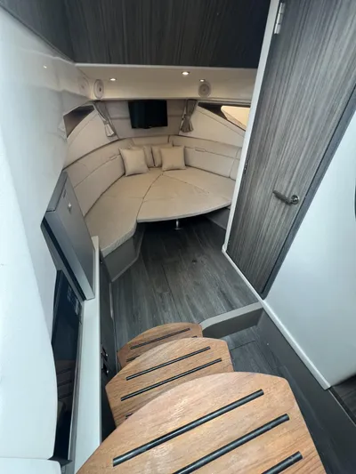  Yacht Photos Pics 2023 Sea Ray Sundancer 320 cabin interior with modern design and wooden steps.