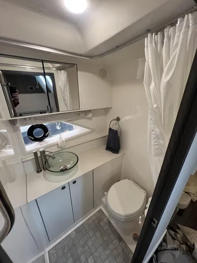  Yacht Photos Pics 2023 Sea Ray Sundancer 320 bathroom with modern fixtures and glass sink.