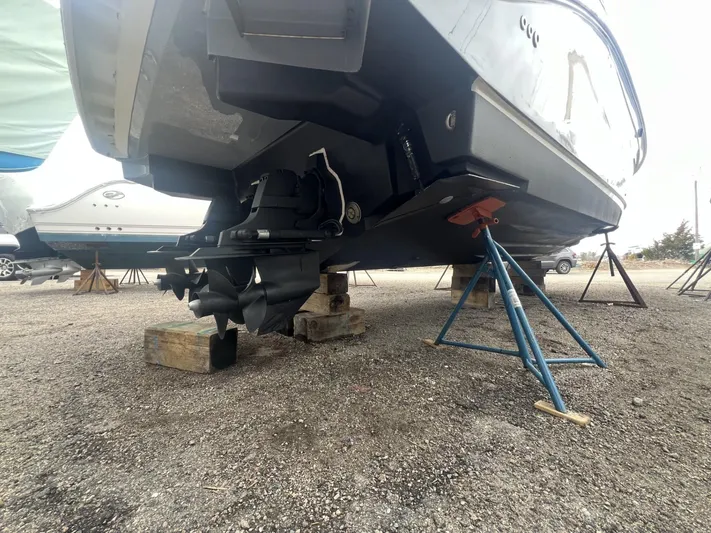  Yacht Photos Pics 2023 Sea Ray Sundancer 320 boat on stands, showing propeller and hull details.