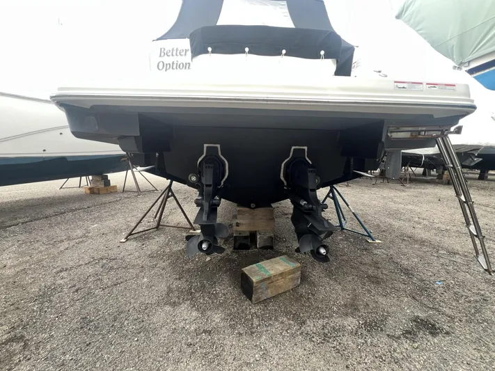  Yacht Photos Pics 2023 Sea Ray Sundancer 320 boat on dry dock, rear view with dual propellers.