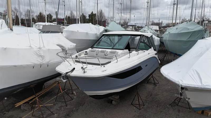  Yacht Photos Pics 2023 Sea Ray Sundancer 320 boat in storage, surrounded by covered boats.