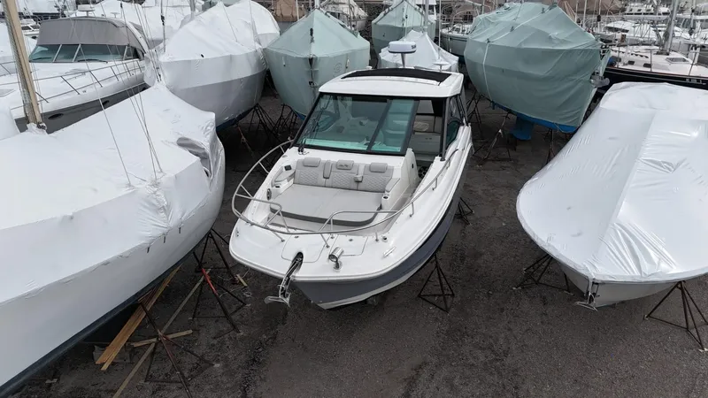 Yacht Photos Pics 2023 Sea Ray Sundancer 320 boat in storage, surrounded by covered boats.