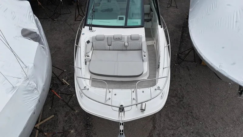  Yacht Photos Pics 2023 Sea Ray Sundancer 320 boat, aerial view, docked with protective covers nearby.