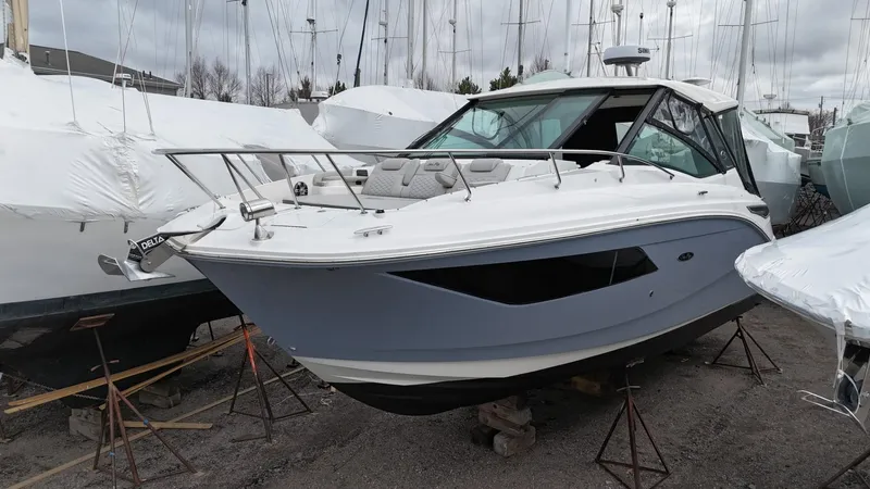  Yacht Photos Pics 2023 Sea Ray Sundancer 320 boat on stands, surrounded by other covered boats.