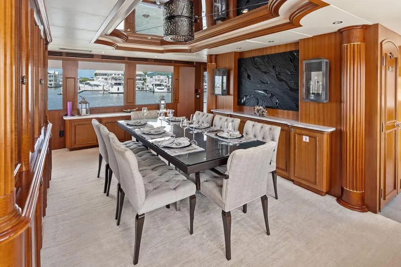 Magnum Ride Yacht Photos Pics Luxurious dining area on 2004 Hatteras 100 Motor Yacht with elegant decor and waterfront view.