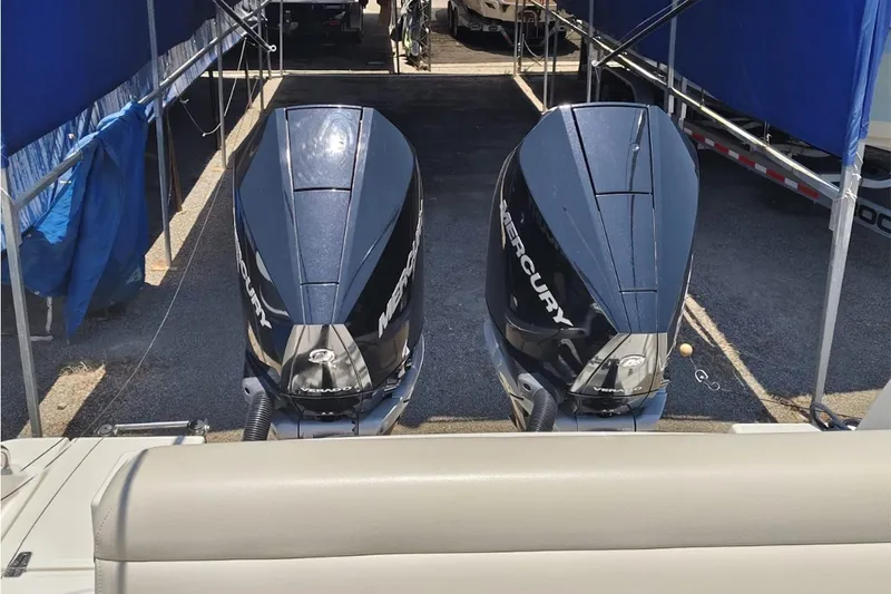 2024 Boston Whaler 280 Outrage @ Vallarta Yacht Photos Pics 2024 Boston Whaler 280 Outrage with dual Mercury outboard engines, docked under blue canopy.