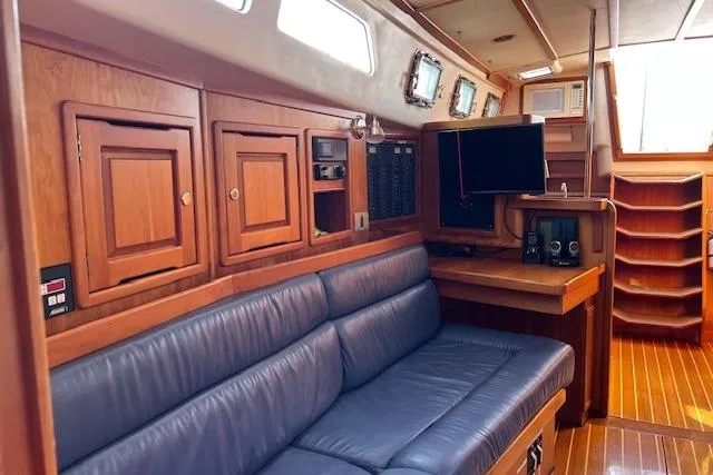 No Se Yacht Photos Pics Interior of 2004 Saga 43CLS yacht with wooden cabinetry and blue seating.