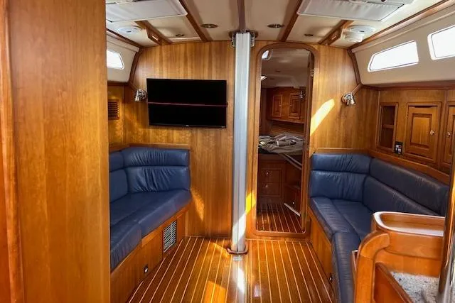 No Se Yacht Photos Pics Interior of 2004 Saga 43CLS yacht with wooden finish and blue seating.