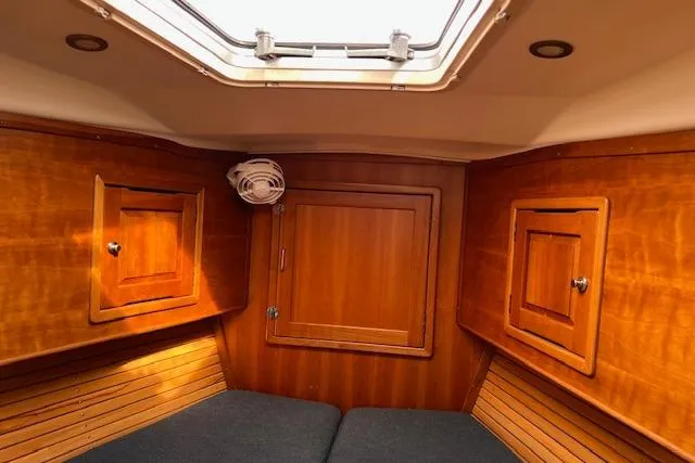No Se Yacht Photos Pics Cozy cabin interior of 2004 Saga 43CLS sailboat with wooden paneling and skylight.