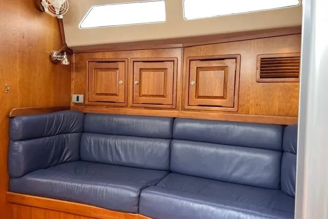 No Se Yacht Photos Pics Interior of 2004 Saga 43CLS yacht with blue leather seating and wooden cabinets.