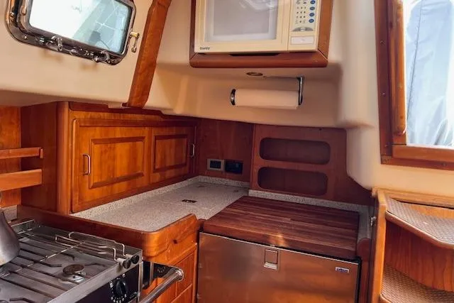 No Se Yacht Photos Pics Cozy kitchen in 2004 Saga 43CLS yacht with wooden cabinetry and modern appliances.