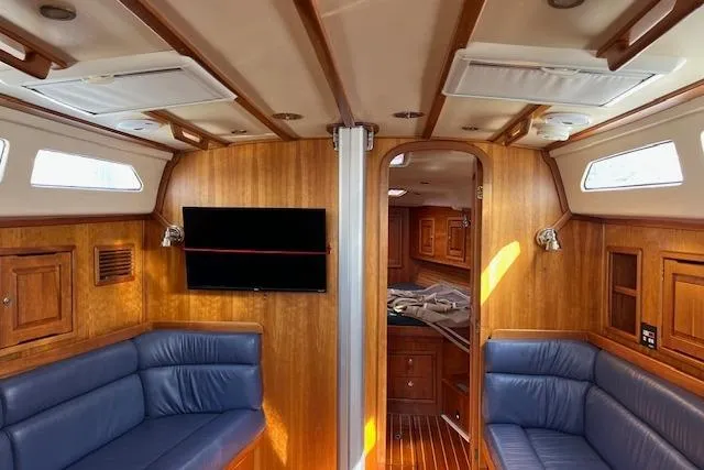 No Se Yacht Photos Pics Interior of 2004 Saga 43CLS yacht with wooden paneling and blue seating.