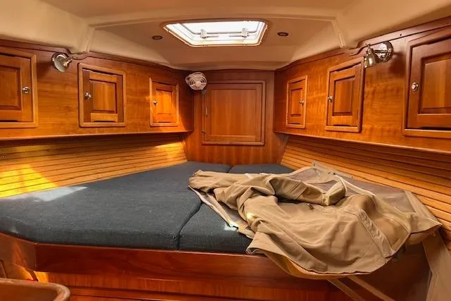 No Se Yacht Photos Pics Cozy cabin interior of 2004 Saga 43CLS yacht with wooden finish and skylight.