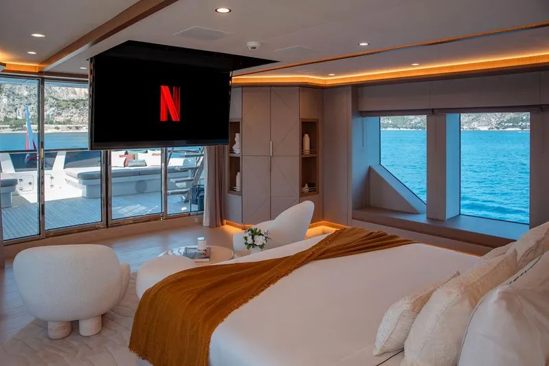Infinity Nine Yacht Photos Pics Luxurious AvA Yachts Kando 2022 interior with ocean view, modern decor, and Netflix on TV.