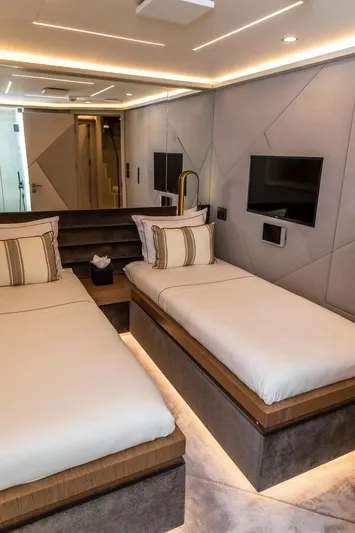 Infinity Nine Yacht Photos Pics Luxurious twin bedroom on 2022 AvA Yachts Kando, featuring modern design and elegant lighting.