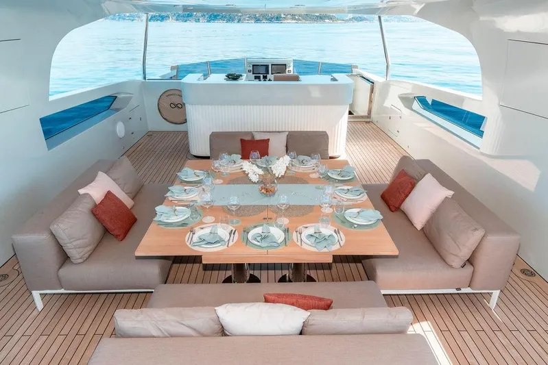 Infinity Nine Yacht Photos Pics Luxurious dining area on 2022 AvA Yachts Kando, featuring elegant table settings and plush seating.