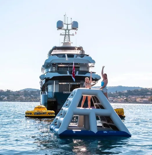 Infinity Nine Yacht Photos Pics Luxury AvA Yachts Kando 2022 with inflatable water toys in scenic ocean setting.
