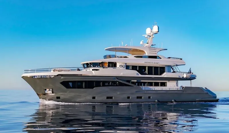 Infinity Nine Yacht Photos Pics Luxurious 2022 AvA Yachts Kando cruising on calm waters under a clear blue sky.