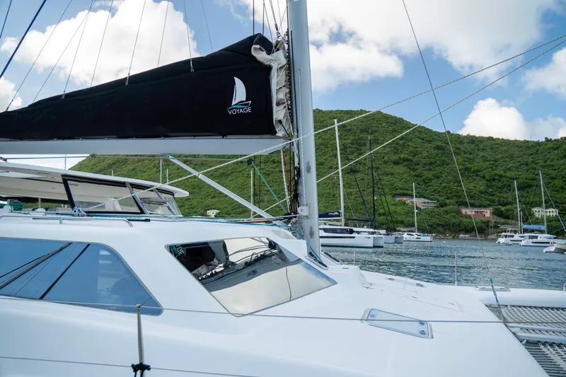  Yacht Photos Pics 2017 Voyage Yachts VOYAGE 480 catamaran docked in scenic marina with lush hills.