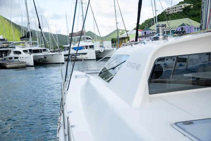  Yacht Photos Pics 2017 Voyage Yachts VOYAGE 480 docked in a scenic marina with surrounding boats.