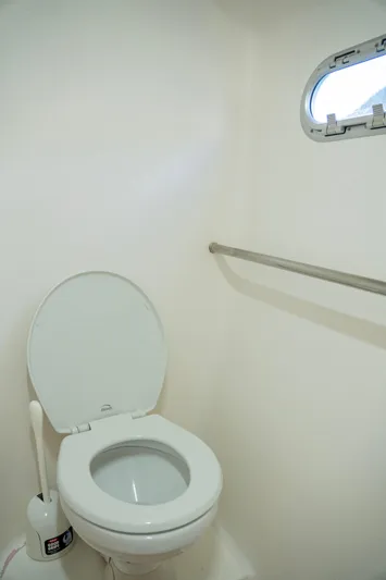  Yacht Photos Pics 2017 Voyage Yachts VOYAGE 480 bathroom with toilet and porthole window.