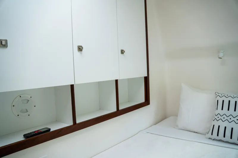  Yacht Photos Pics Interior cabin of 2017 Voyage Yachts VOYAGE 480 with white bedding and storage cabinets.