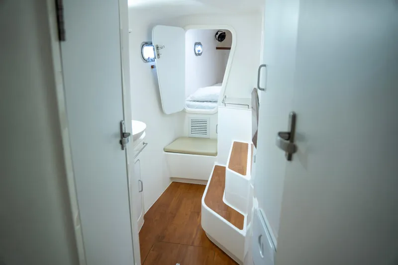  Yacht Photos Pics Interior of 2017 Voyage Yachts VOYAGE 480, featuring a cozy cabin with wooden flooring.