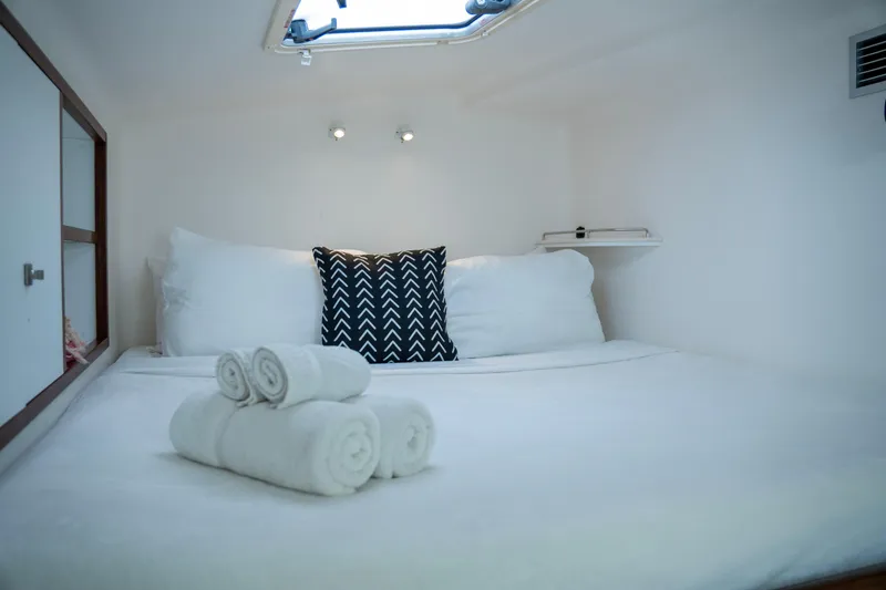  Yacht Photos Pics Cozy cabin interior of 2017 Voyage Yachts VOYAGE 480 with neatly arranged bed and towels.