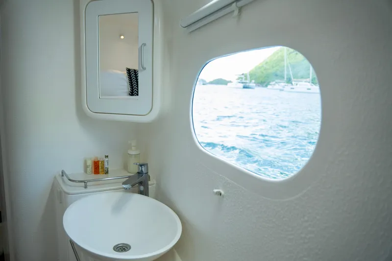  Yacht Photos Pics Bathroom interior of 2017 Voyage Yachts VOYAGE 480 with ocean view through window.