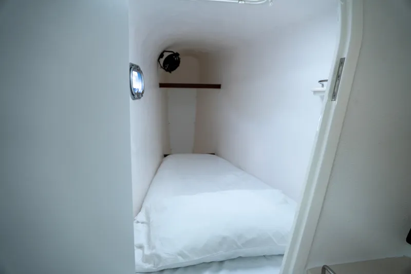  Yacht Photos Pics Compact cabin interior of 2017 Voyage Yachts VOYAGE 480 with a single bed.