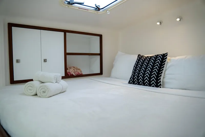  Yacht Photos Pics Cozy cabin interior of 2017 Voyage Yachts VOYAGE 480 with bed and storage.