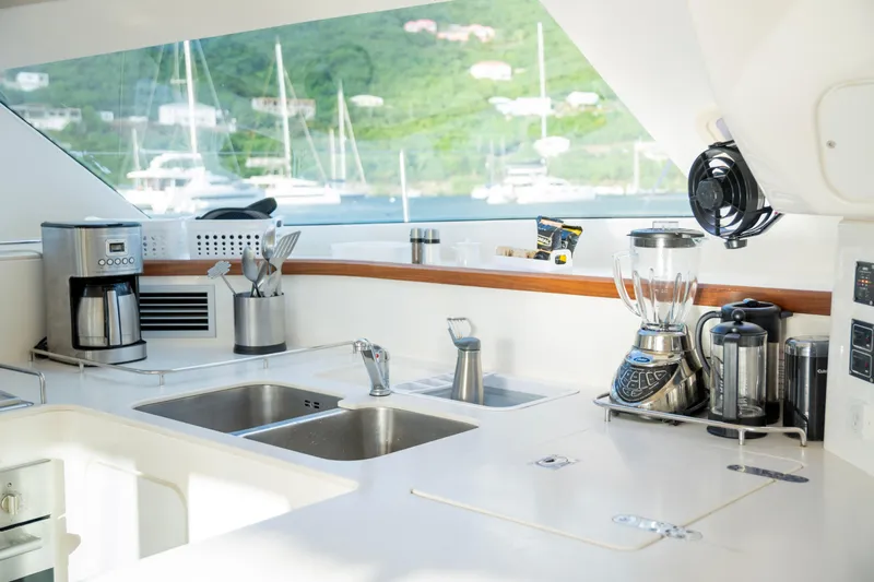  Yacht Photos Pics Modern kitchen on 2017 Voyage Yachts VOYAGE 480, featuring appliances and scenic marina view.