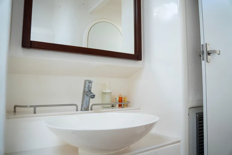  Yacht Photos Pics Modern bathroom interior on 2017 Voyage Yachts VOYAGE 480, featuring sleek sink and mirror.