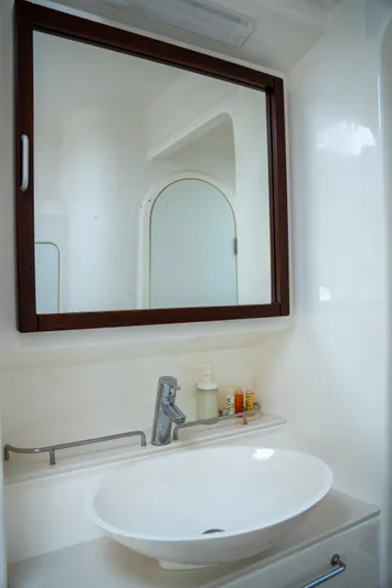  Yacht Photos Pics Modern bathroom vanity on 2017 Voyage Yachts VOYAGE 480, featuring sleek sink and mirror.