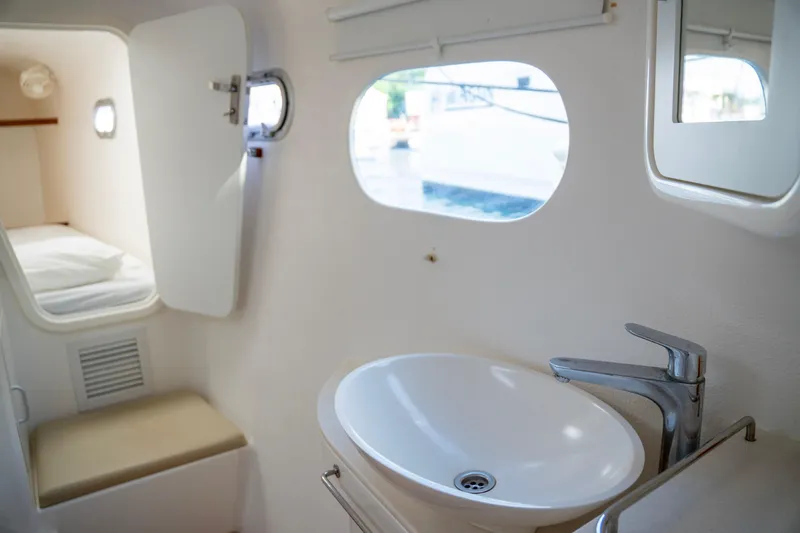  Yacht Photos Pics Interior of 2017 Voyage Yachts VOYAGE 480, featuring a compact bathroom and adjacent sleeping area.