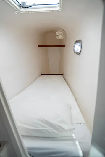  Yacht Photos Pics Compact cabin bed in 2017 Voyage Yachts VOYAGE 480 with porthole and fan.