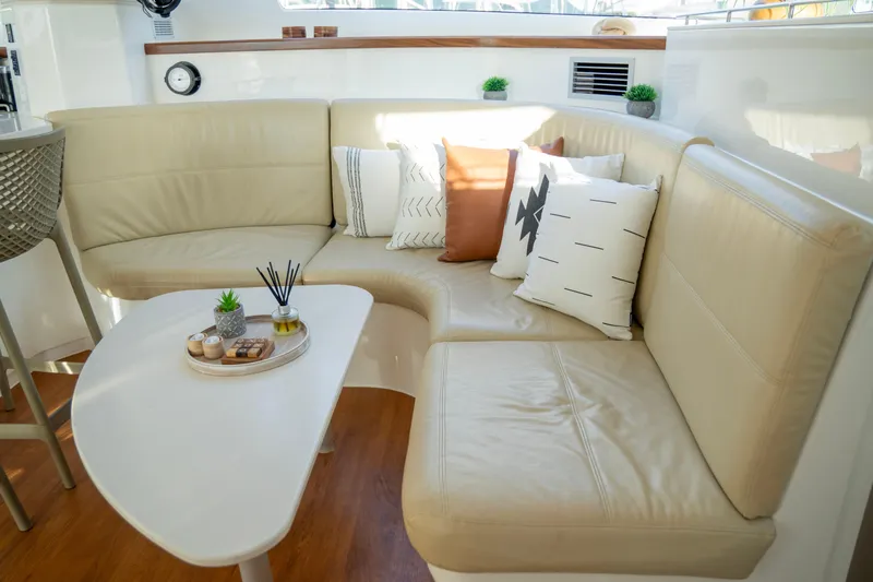  Yacht Photos Pics Luxurious interior of 2017 Voyage Yachts VOYAGE 480 with beige seating and decorative pillows.