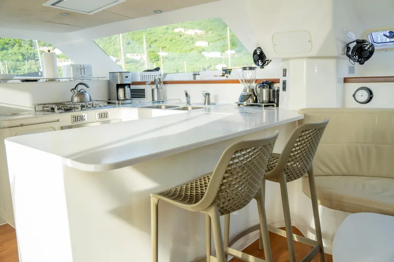 Yacht Photos Pics Modern kitchen interior on 2017 Voyage Yachts VOYAGE 480, featuring sleek countertops and seating.
