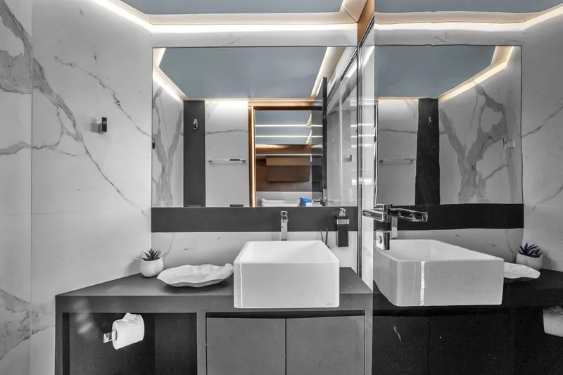  Yacht Photos Pics Modern bathroom with dual sinks and marble walls on OKEAN 80 yacht, 2021 model.