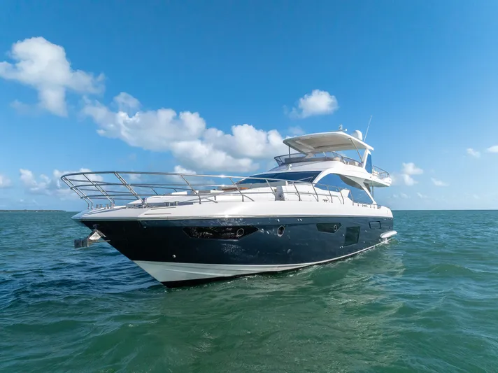 Mancusa Yacht Photos Pics Azimut Fly 72 yacht, 2016 model, cruising on open sea under clear blue sky.